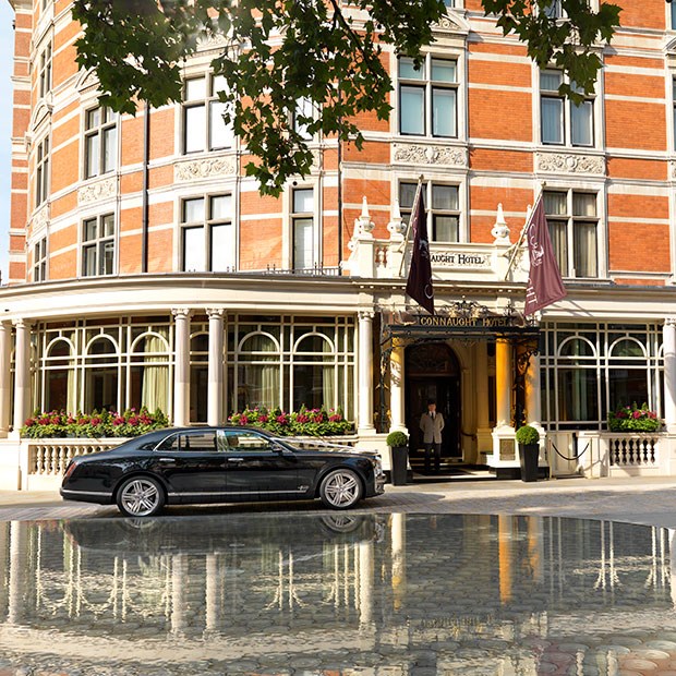 car parked outside The Connaught hotel on sunny day in London