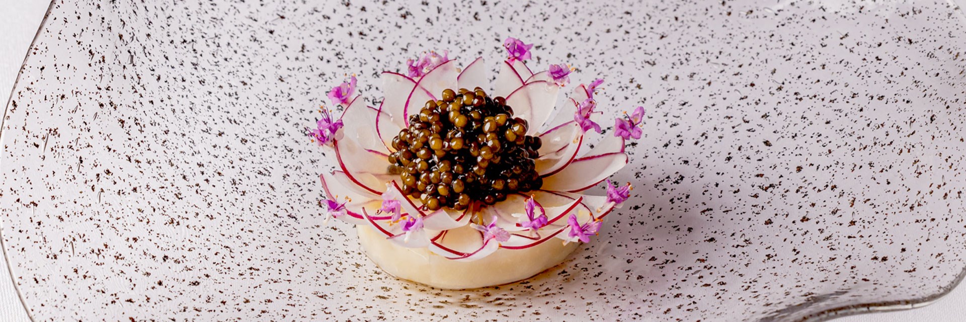 caviar dish with flaked radishes assembled to form a flower