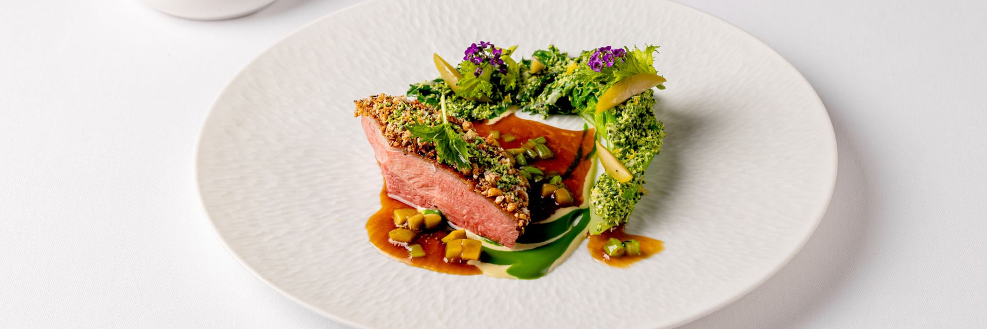 Helene Darroze red meat dish served with green vegetables