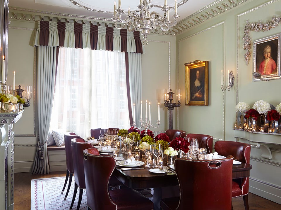 View of the dining table set in the Georgian Room at The Connaught, luxuriously decorated with floral arrangements.