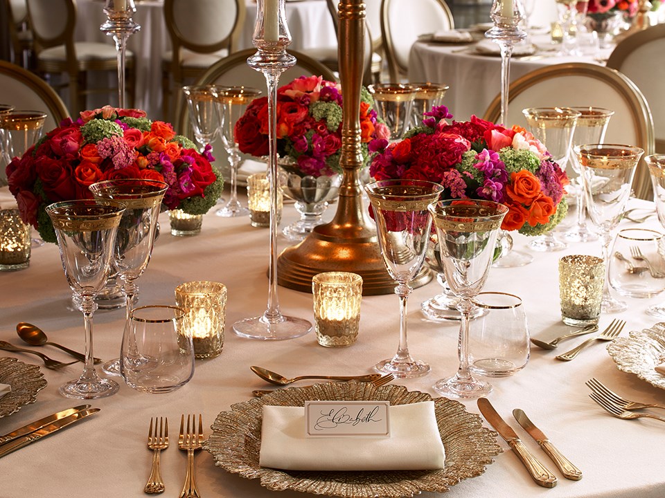 A table beautifully dressed with tableware, cutlery and flowers in the Mayfair Room at The Connaught
