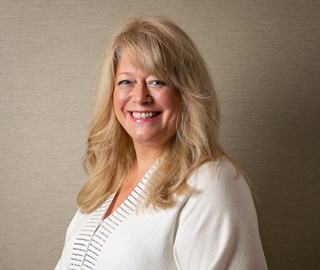 Portrait of a smiling Bernice Robinson, one of the Reiki experts at Aman Spa.