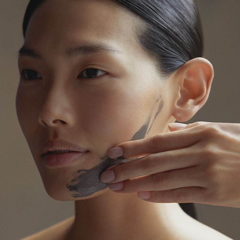 Woman having dark treatment applied to her face during a facial