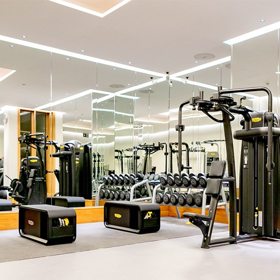 The Connaught gym with stacks of dumbells, a chest press machine and benches