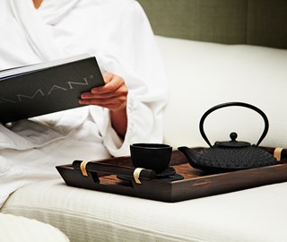 View the relaxed atmosphere with tea and reading a book at Aman Spa by The Connaught.