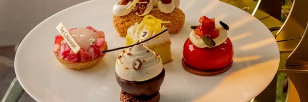Close-up of the middle tier of The Connaught’s afternoon tea with intricate seasonal patisserie.