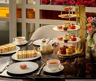 Spring Afternoon Tea spread at The Connaught, with tea, sandwiches, scones, and desserts.