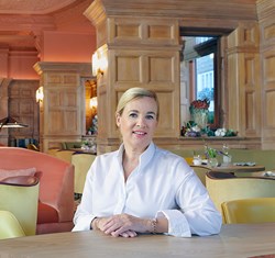 A portrait of a smiling H�l�ne Darroze, a French chef, photographed in a bright setting, at The Connaught.