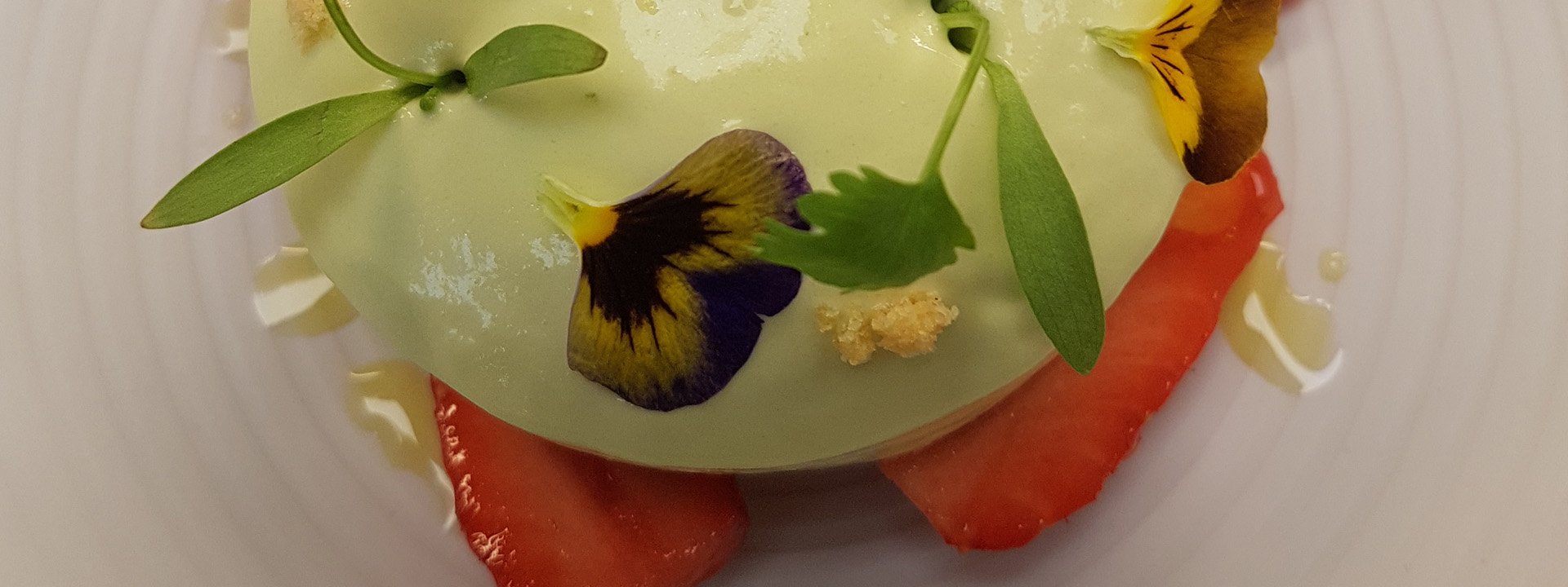 Strawberries with green cream on top.