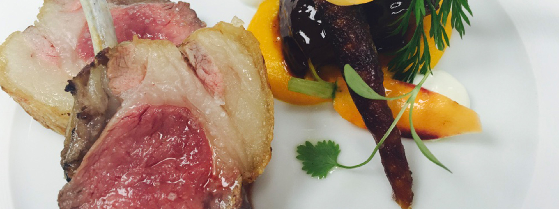 
Meat with side dish on a white plate.