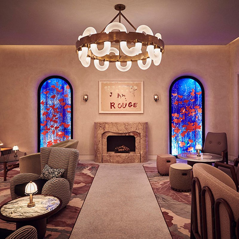 A view of The Red Room, with its works of art and comfortable armchairs give a warm atmosphere in a luxurious interior.