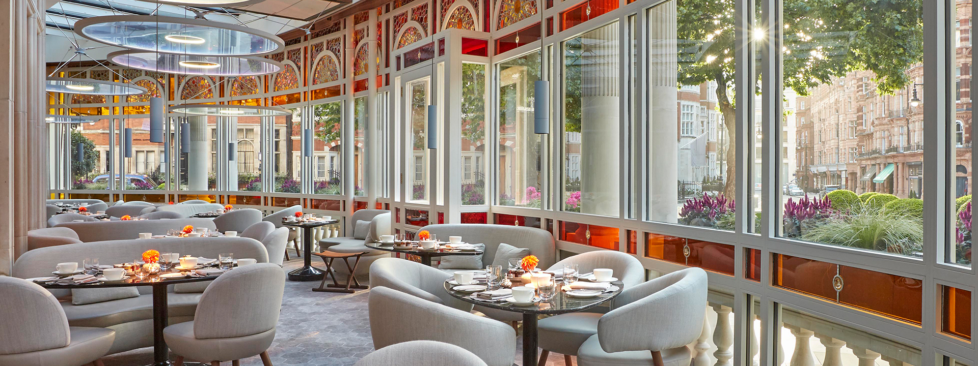 The seating area at the Jean-Georges at The Connaught restaurant with ceiling to floor windows.