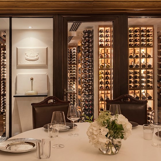 Part of the luxurious interior of The Sommelier's Table, as well as a rich wine collection.