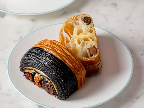 Trio au chocolat with a cross section beside it, positioned on a white plate