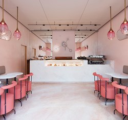 A chic palette of pink colours in the interior from The Connaught Patisserie with a playful feature clock.
