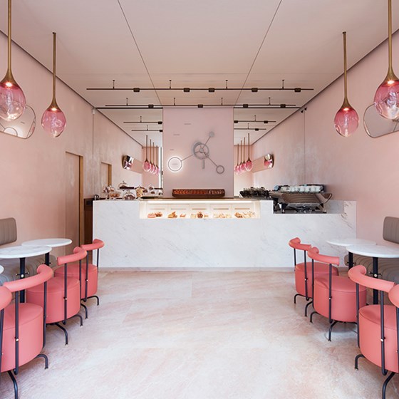 A chic palette of pink colours in the interior from The Connaught Patisserie with a playful feature clock.