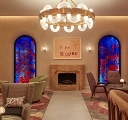 A view of The Red Room, with its works of art and comfortable armchairs give a warm atmosphere in a luxurious interior.