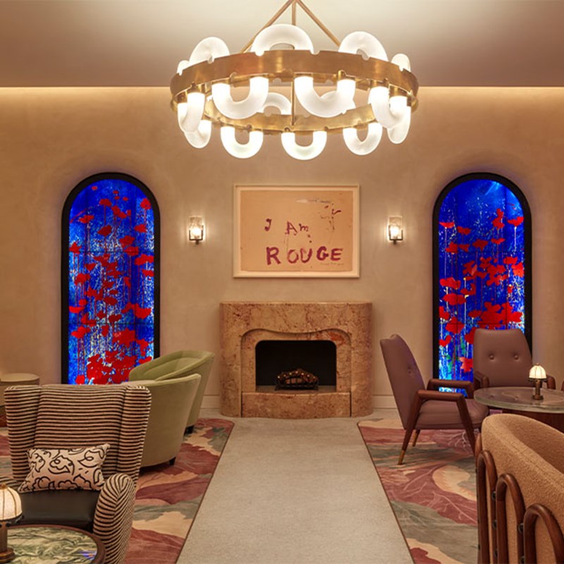 A view of The Red Room, with its works of art and comfortable armchairs give a warm atmosphere in a luxurious interior.