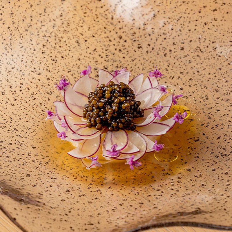 Caviar dish with radishes arranged into a flower.