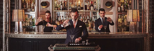 The Connaught Bar - staff pouring drinks in front and behind the bar.