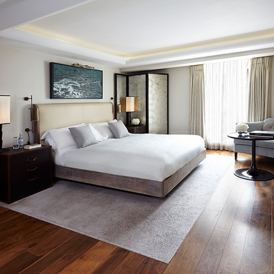 The bedroom of the Contemporary Studio at The Connaught with a bed, bedside tables and the window in the background.