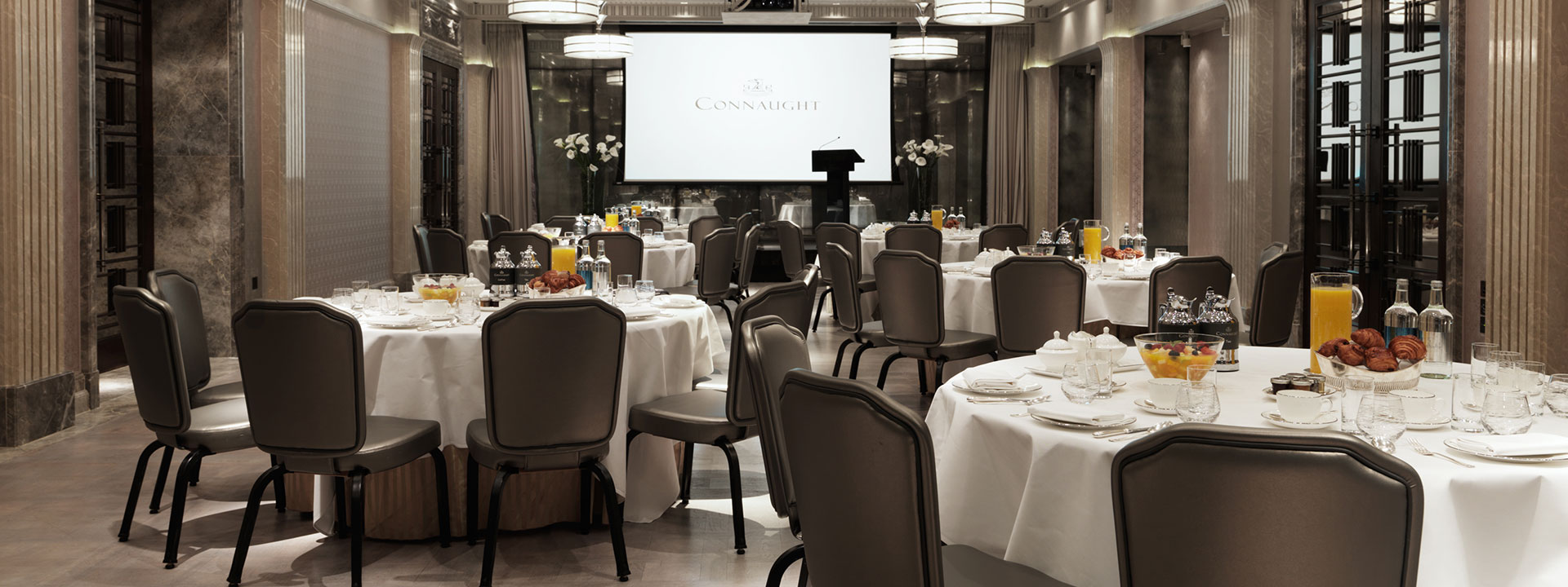 A view of the business event space, complete with comfortable chairs and tables at The Connaught.