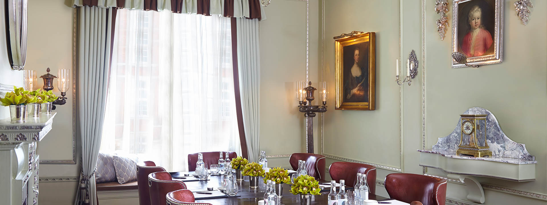 View of the Georgian Room at The Connaught, with original artwork on the walls in its peaceful atmosphere.