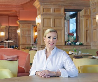 A portrait of a smiling H�l�ne Darroze, a French chef, photographed in a bright setting, at The Connaught.