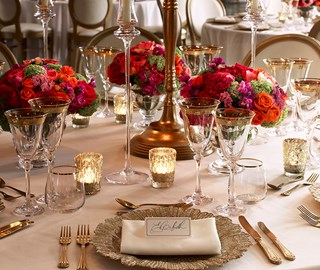 A table beautifully dressed with tableware, cutlery and flowers in the Mayfair Room at The Connaught