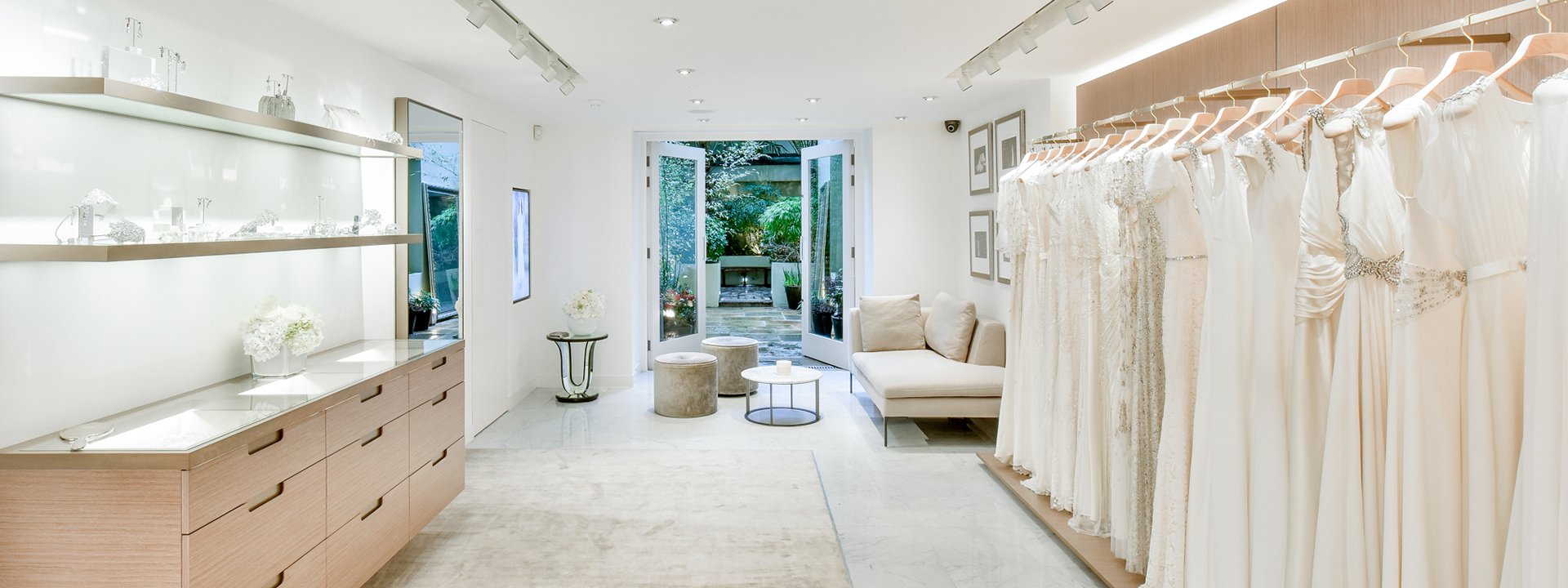 Display of Jenny Packham wedding dresses in a minimal and romantic space in natural tones of the colour palette.