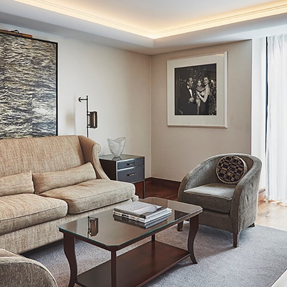 The Adams Suite's living room with a couch, a coffee table and an armchair.