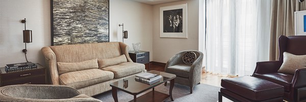 The lounge with a sofa, armchairs and coffee table at The Adams Suite at The Connaught