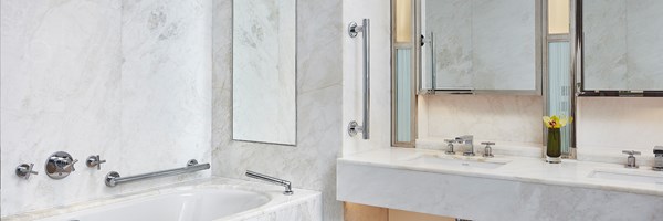 A bathroom with a bathtub and two sinks at The Adams Suite at The Connaught