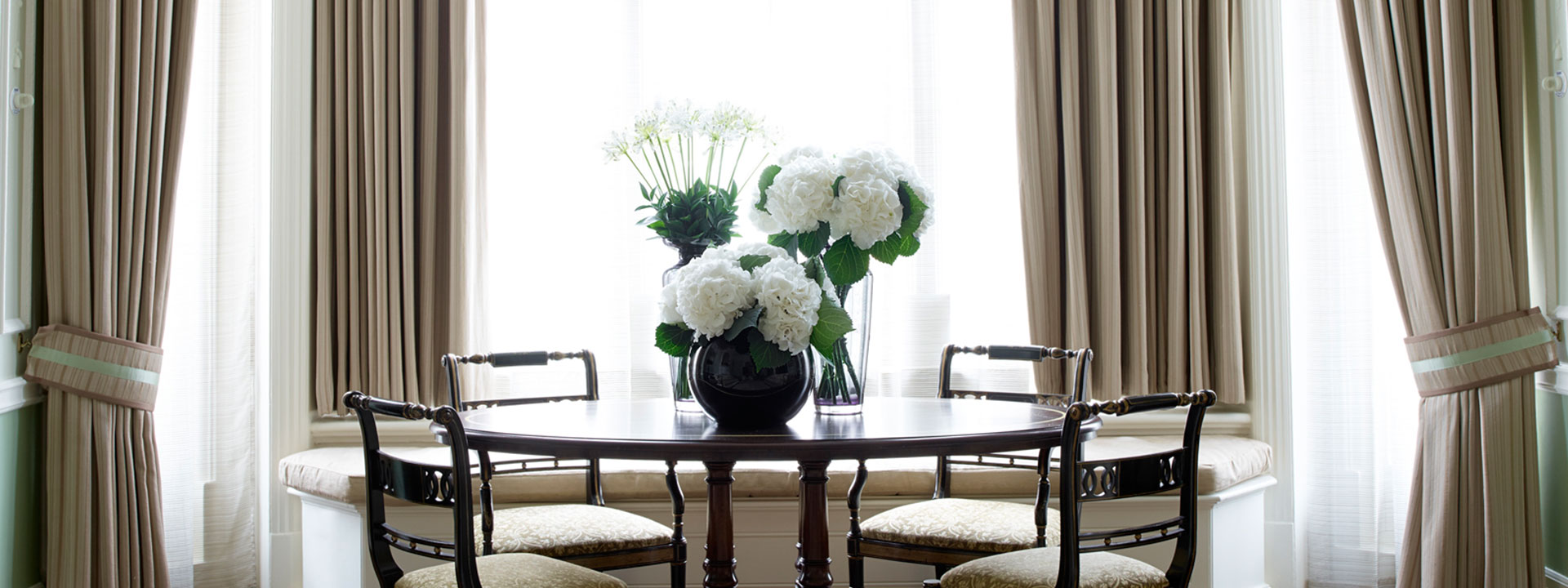 Flower arrangement on the dining table in The Connaught, in a luxurious interior.