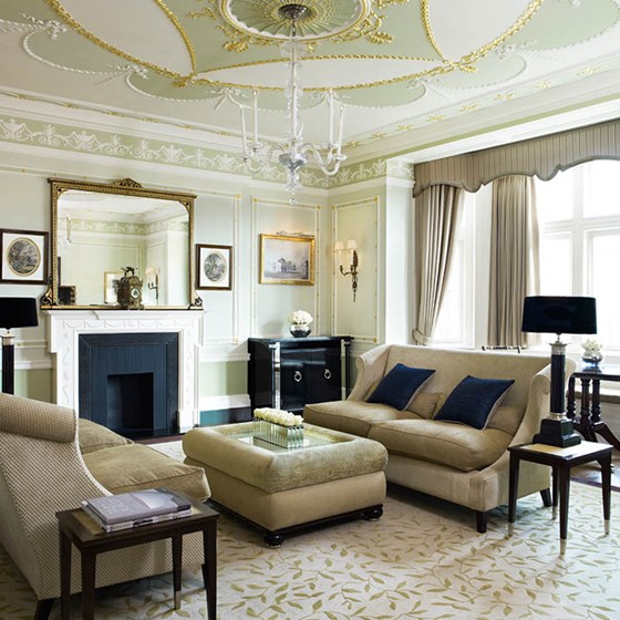 A smart and modern chandeliered sitting room in The Connaught Suite, with lots of natural light.