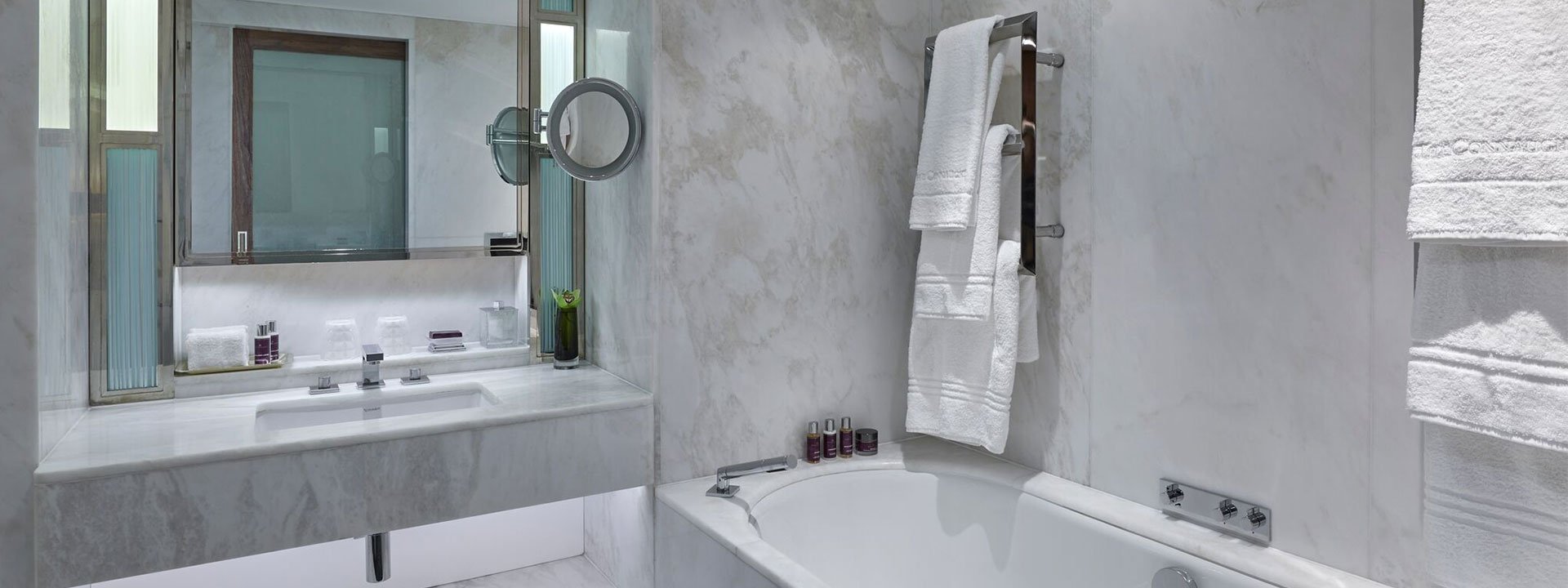 View of the Contemporary Superior Room's marble bathroom, complete with towels and amenities.