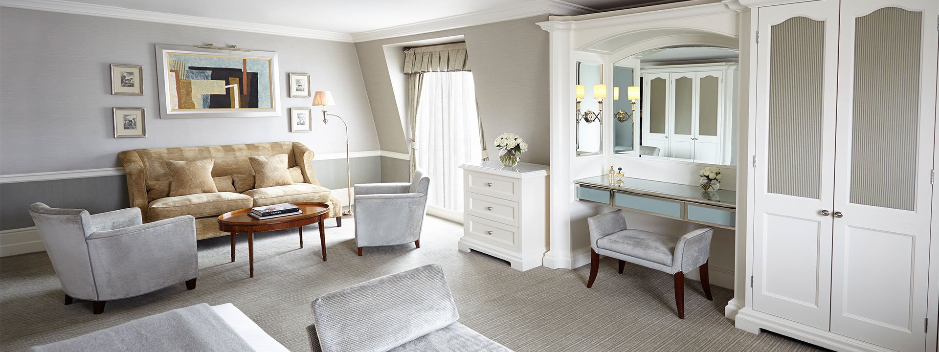 Part of the space from the Deluxe Junior Suite at The Connaught, in a traditional interior style with comfortable furniture.