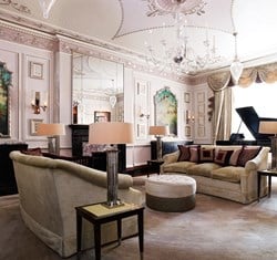 A spacious drawing room from the Sutherland Suite, with comfortable sofas and a 1909 Steinway grand piano.