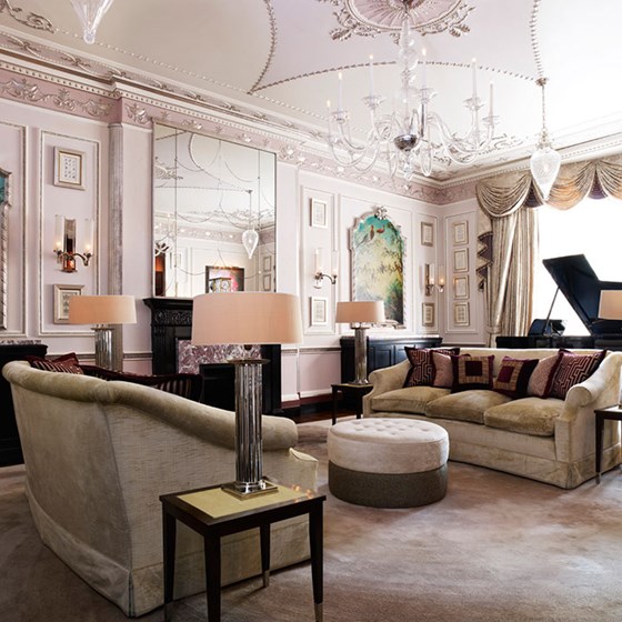 A spacious drawing room from the Sutherland Suite, with comfortable sofas and a 1909 Steinway grand piano.