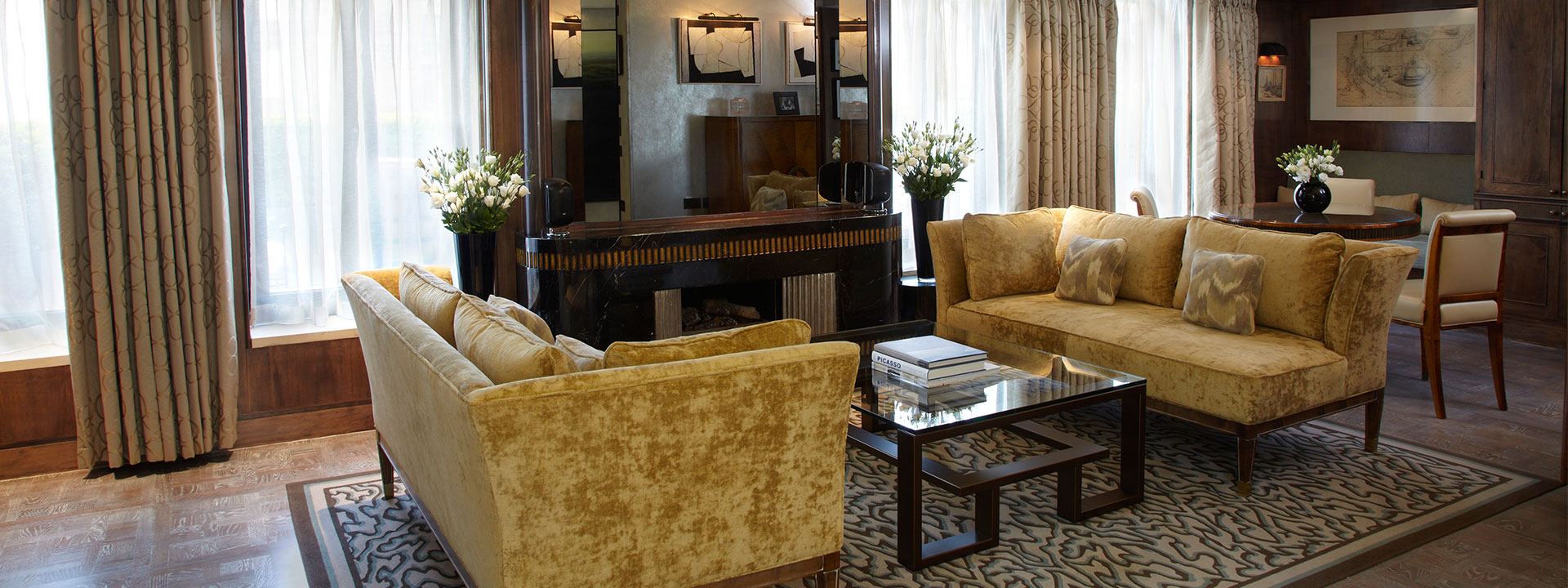 Living room with comfortable yellow sofas in the contemporary Terrace Suite at The Connaught interior.