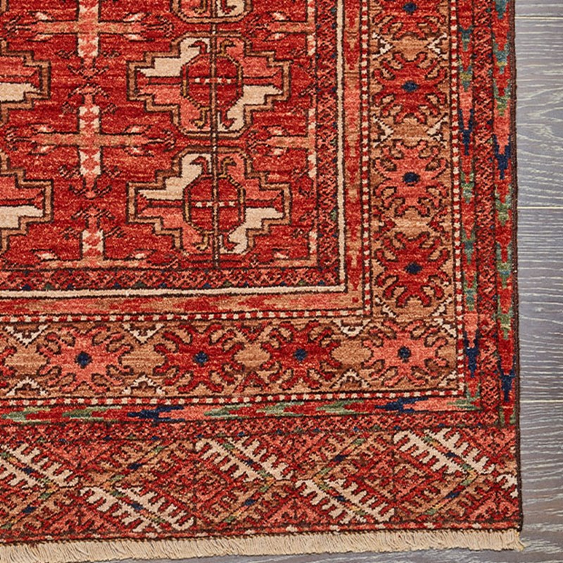 close up detail of Afghan carpet, with  striking zig-zag motifs which take their cue from chevroned Mughal columns, woven through with jewel-box tones inspired by the materials of Doha’s Museum of Islamic Art.