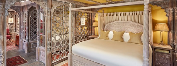 Bedroom of The King's Lodge with intricate carved wooden sections