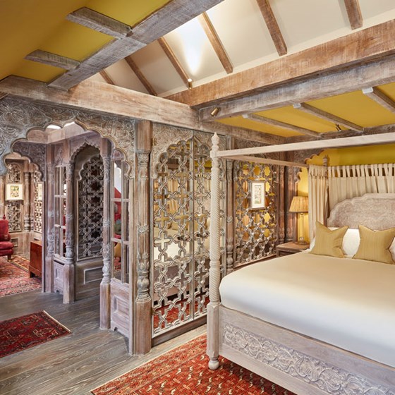 Bedroom of The King's Lodge with intricate carved wooden sections