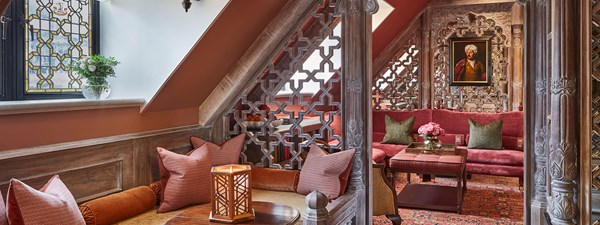 Living area of The King's Lodge with plush red sofas