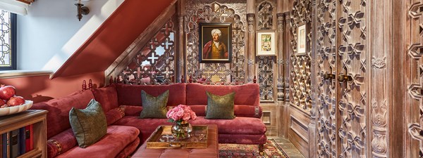 Living area of The King's Lodge with plush red sofas