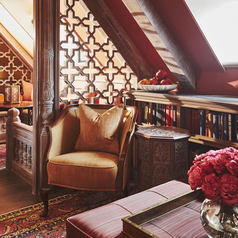 Mustard coloured armchair in the corner of living area in The King's Lodge