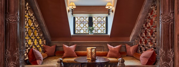 Living area of The King's Lodge with plush red sofas