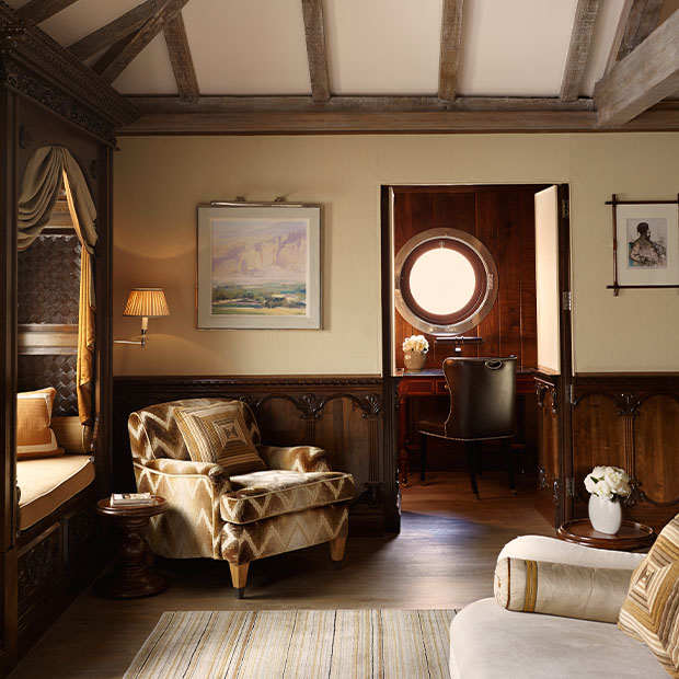 osy lounge with armchair and a small study room featuring a round porthole window