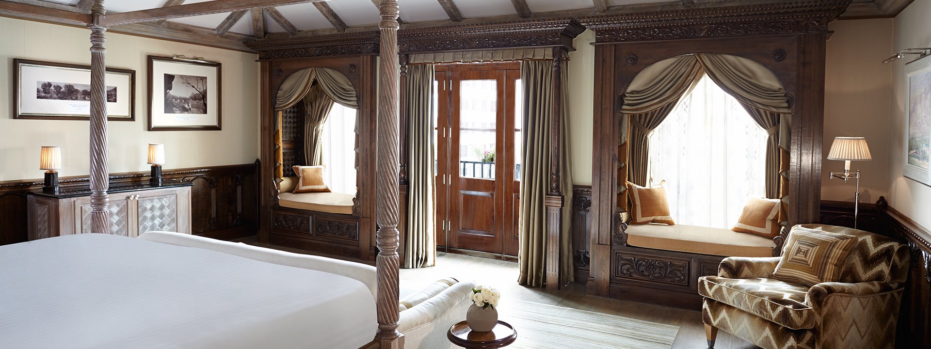 Entrance to the room with two windows, a sofa and a lamp from the perspective of the bed at the Princes Lodge Room.