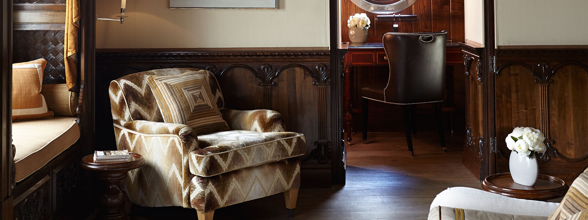 Details of The Prince's Lodge room at The Connaught, a comfortable armchair hand-carved from Kabul.